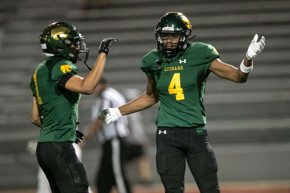 Kennedy’s Cyrus Courtney (4) celebrates a touchdown with teammate Pierce McCrary (1) during a home football game against Dubuque Hempstead on Thursday, Oct. 5, 2023, Kingston Stadium in Cedar Rapids, Iowa. The Cougars defeated the Mustangs 44-0. (Geoff Stellfox/The Gazette)