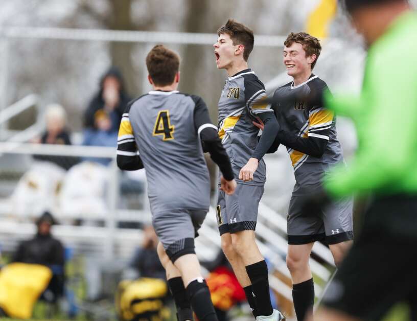 Center Point-Urbana's Bradley Jones (center) celebrates his goal with teammates during the first half of their boy's soccer match against the Benton Community Bobcats at Fross Park in Center Point, Iowa, on Thursday, April 20, 2023. (Jim Slosiarek/The Gazette)