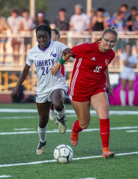 Iowa City Liberty midfielder Eno Ituk (24) and Marion Gracie Schwartz midfielder (15) battle for possession of the ball in the second half of the game at Marion High School in Marion, Iowa on Thursday, May 25, 2023. (Savannah Blake/The Gazette)