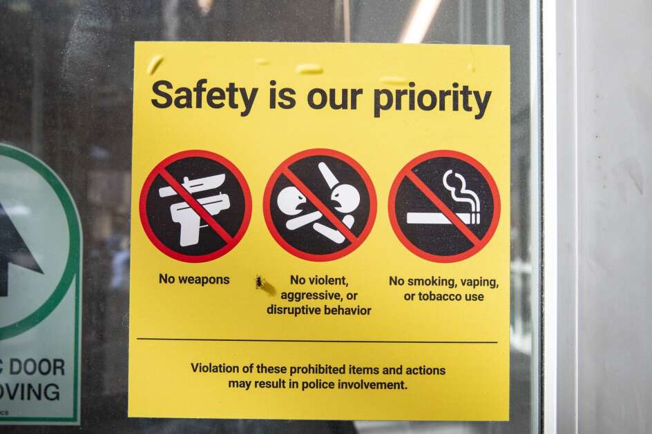 A sign prohibiting weapons, smoking and violent behavior hangs at the main entrance to  University of Iowa Hospitals in Iowa City on Friday. A bill passed by Iowa House lawmakers would allow guns in school and college parking lots. The bill, among other provisions, allows anyone who can legally carry a firearm to keep it in their locked vehicle in the parking lots of schools, city and county buildings, state universities and prisons. (Nick Rohlman/The Gazette)