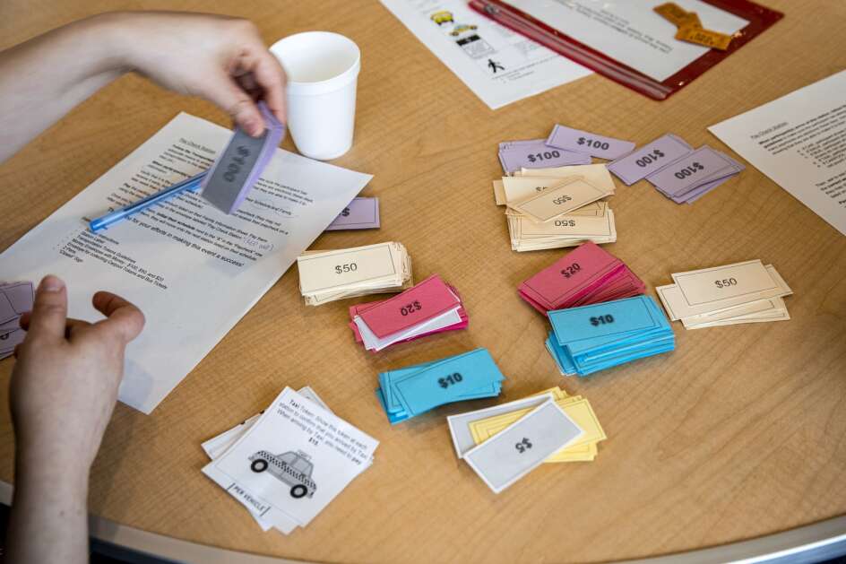 Paper money to be distrubted as “paychecks” to participants during a poverty simulation hosted by the Catherine McAuley Center at St. Mark’s Lutheran Church in Marion on Saturday, April 15, 2023. (Nick Rohlman/The Gazette)