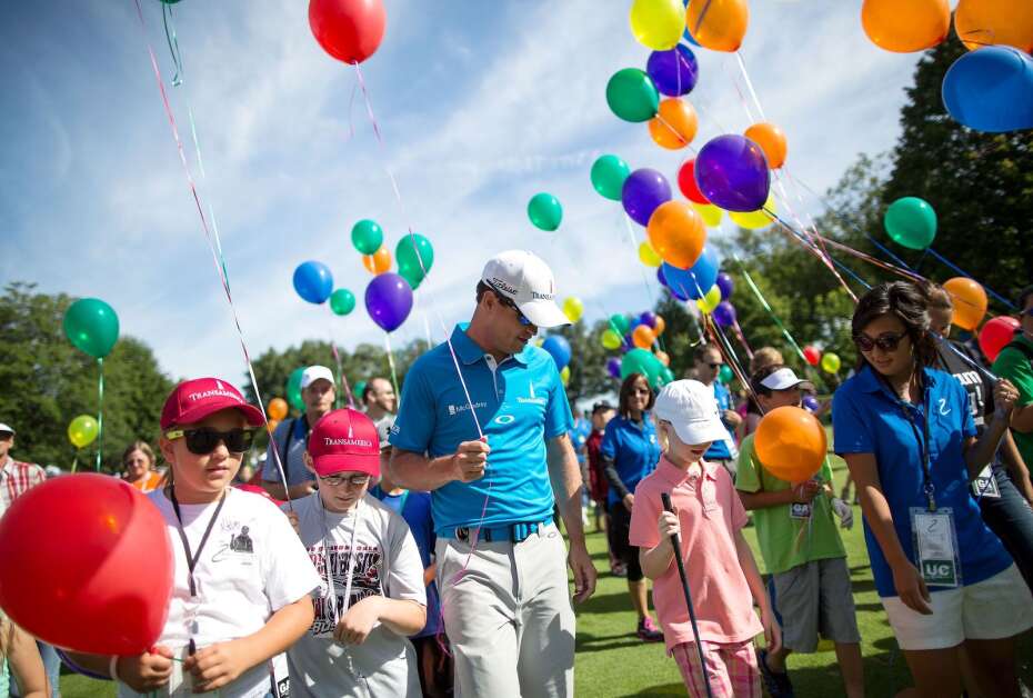 PGA Tour professional Zach Johnson walks down the first fairway with participants in the Kids on Course program for the opening of the Zach Johnson Foundation Classic Monday, July 29, 2013 at Elmcrest Country Club in Cedar Rapids .  (Brian Ray/The Gazette-KCRG)