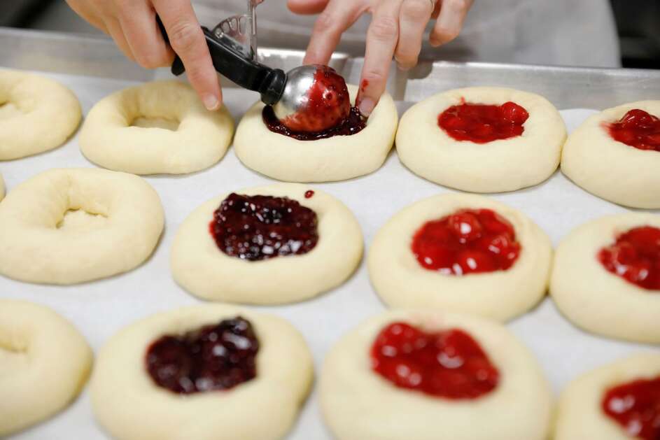 Cheryl Maloney fills kolaches with homemade berry jam at The Eat Shop in Solon on Tuesday, Oct. 12, 2021. The bakery started out as a restaurant run by the owner's great aunt Mary Ann Drahos and her five sisters. (The Gazette)