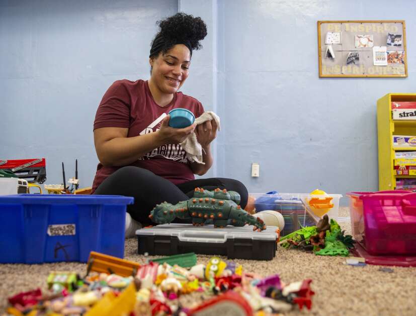 CRST employee Taneka Smith smiles as she works on disinfecting toys while volunteering for Day of Caring at Jane Boyd Community House in Cedar Rapids, Iowa on Thursday, May 11, 2023. (Savannah Blake/The Gazette)