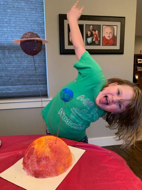 Aislinn Buesing, 8, poses with her homemade solar system model. (Photo contributed by Missy Buesing)