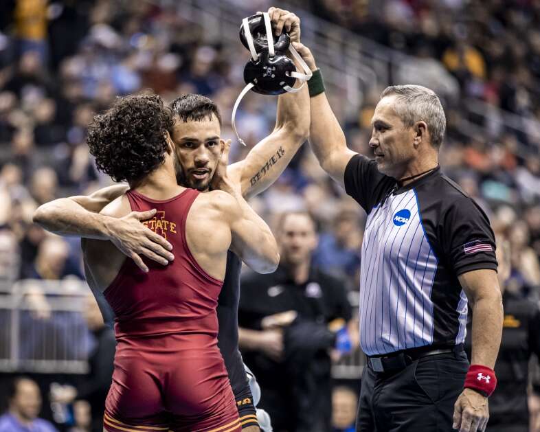 Iowa’s Real Woods embraces Iowa State's Anthony Echemendia after defeating him at 141 pounds during the 2024 NCAA Men’s Wrestling National Championships at the T-Mobile Center in Kansas City, Missouri on Saturday, March 23, 2024. (Nick Rohlman/The Gazette)