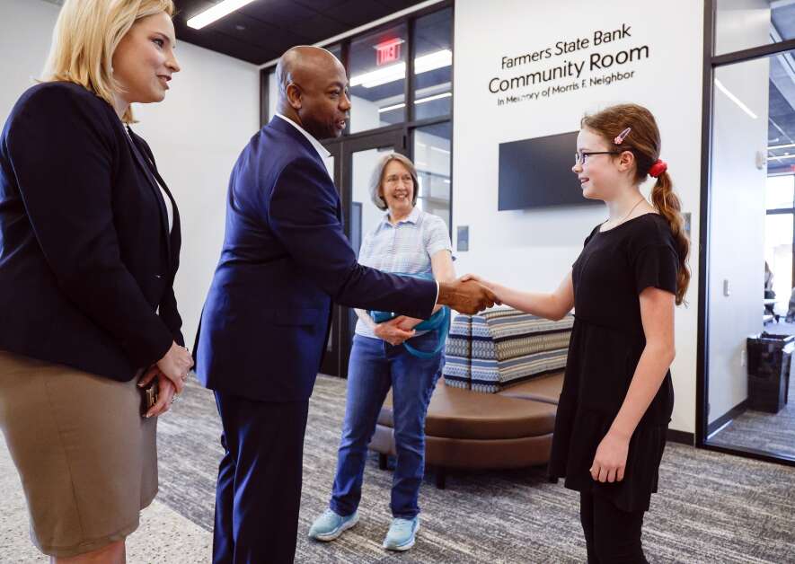 South Carolina Republican U.S. Sen. Tim Scott greets homeschool student Olivia Boyd, 12, before a roundtable discussion with homeschool families as well as Iowa Republican U.S Rep. Ashley Hinson at the Marion Public Library in Marion, Iowa, on Wednesday, April 12, 2023. Scott made multiple stops in Iowa as part of his Faith in America Tour as he makes preparations for a 2024 presidential run. (Jim Slosiarek/The Gazette)