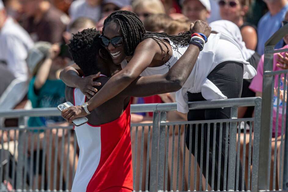 Cedar Rapids Washington’s Miles Thompson embraces his mother Kristyn Barber after winning the Class 4A boys’ state track and field 200-meter dash Saturday at Drake Stadium in Des Moines. (Nick Rohlman/The Gazette)