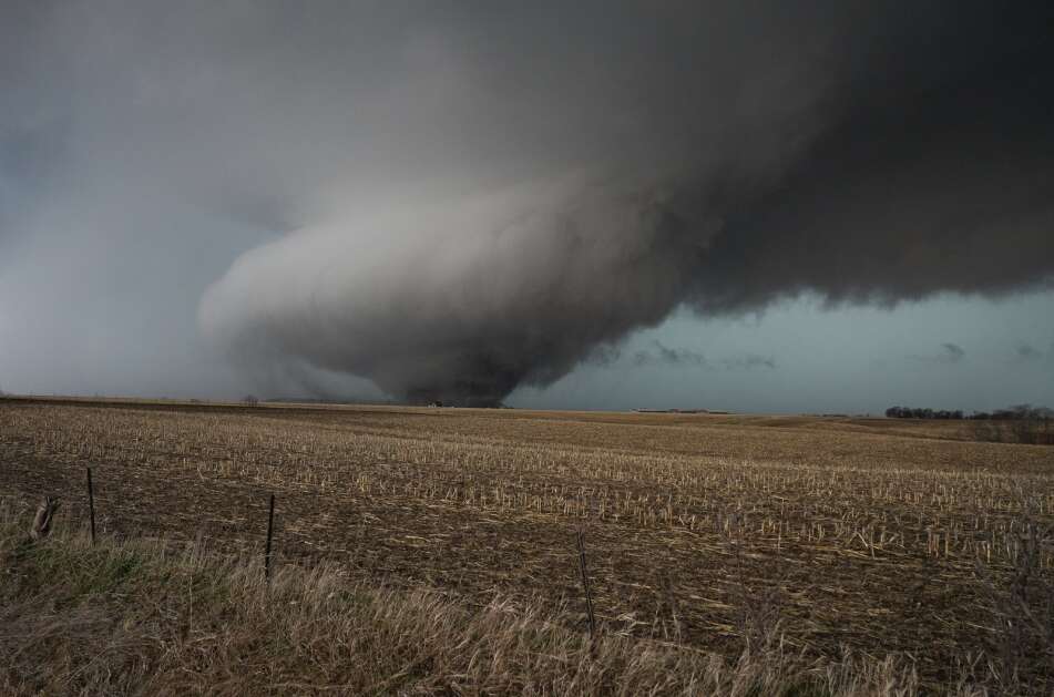 A large tornado carves a path through a cornfield northeast of Keota, in south-central Iowa’s Keokuk County, on March 31 as a band of intense storms hit Iowa. The National Weather Service said an EF4 tornado tracked from Keokuk County into Washington and Johnson counties. (Bryon Houlgrave/Freelance)