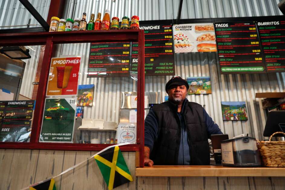 Patrick Rashed, owner of Caribbean Kitchen in NewBo City Market, is moving to a larger site under the same southeast Cedar Rapids roof. He's shown here in January 2022. (Geoff Stellfox/The Gazette)