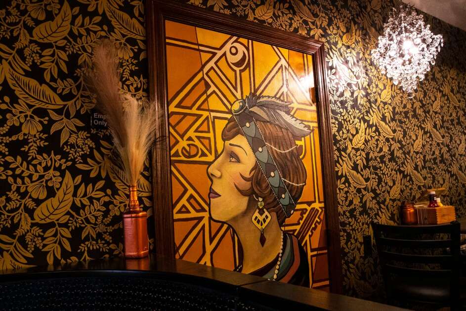 Prohibition era art and Art Deco wallpaper sets the tone for 1920s themed fun on Wednesday, April 26, 2023, at Market at the Tap in Monticello, Iowa. (Geoff Stellfox/The Gazette)