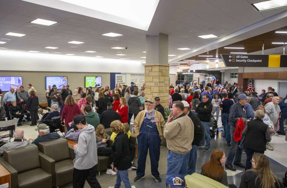 Hundreds of people gather to celebrate the return of the Honor Flight at the Eastern Iowa Airport in Cedar Rapids, Iowa on Tuesday, April 25, 2023. (Savannah Blake/The Gazette)