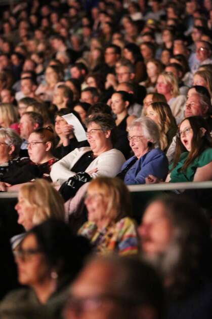 Audience members react April 15 to a design at The Fashion Show at Stephens Auditorium in Ames. The show featured fashion designs produced by Iowa State University students. (Bailey Cichon/The Gazette)