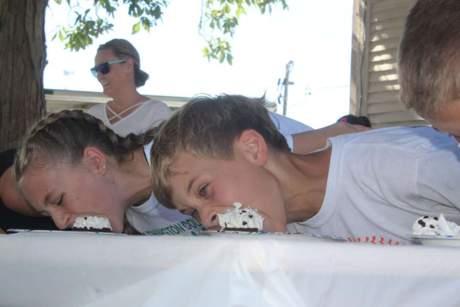 Morgant Bruty (left) and Zachary Hotchkiss get down to business during Monday's pie-eating contest at the Washington County Fair.