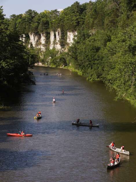 Canoers and kayakers paddle along the Upper Iowa River near Bluffton on June 30 in northeast Iowa. (Jim Slosiarek/The Gazette)