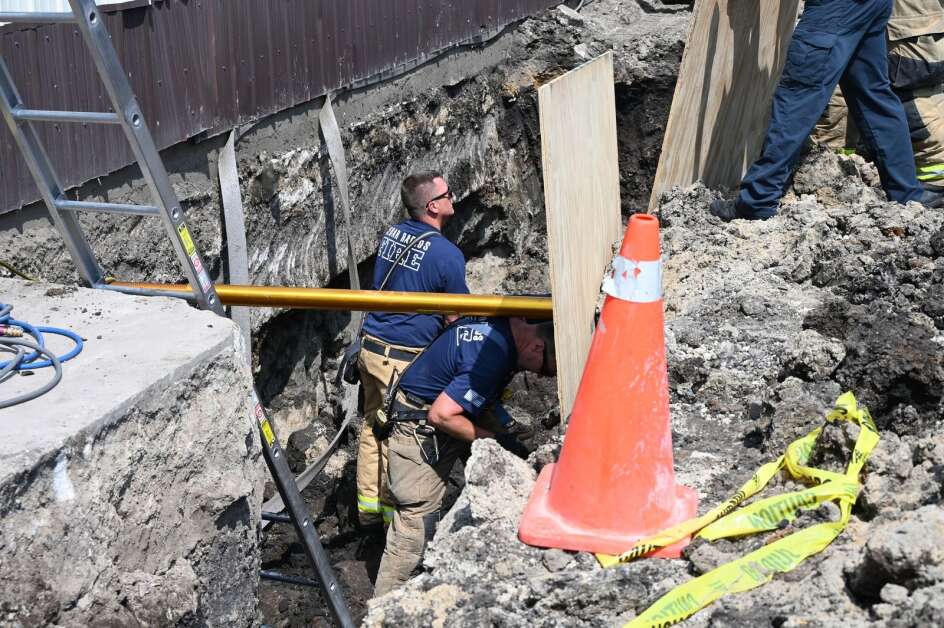Cedar Rapids firefighters work to remove shoring equipment after rescuing a man from a trench that collapsed while he was repairing utility lines Tuesday morning. (Cedar Rapids Fire Department)