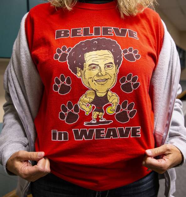 A woman sports a Clark Weaver shirt in support of the departing school board member during a school board meeting at the Linn-Mar Community School District building in Marion, Iowa on Monday, Nov. 20, 2023. (Savannah Blake/The Gazette)