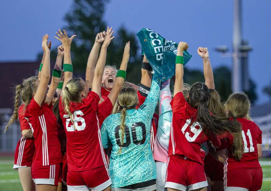 The Wolves celebrate after receiving their state qualifier banner after defeating Liberty at Marion High School in Marion, Iowa on Thursday, May 25, 2023. (Savannah Blake/The Gazette)