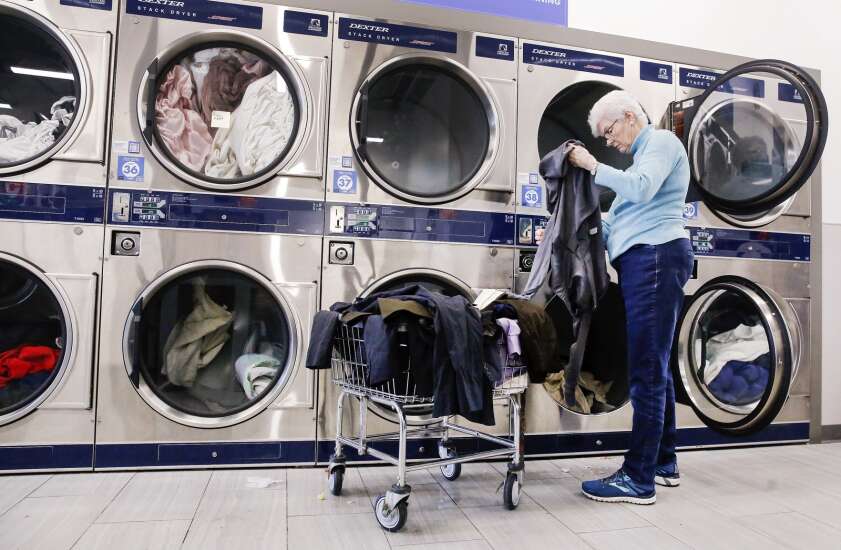 Volunteers wash laundry for displaced Geneva Tower residents