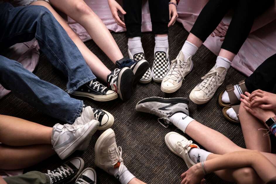 Participants put their feet together as they try to stand up as a team on Thursday, May 4, 2023, at Vernon middle school in Marion, Iowa. (Geoff Stellfox/The Gazette)