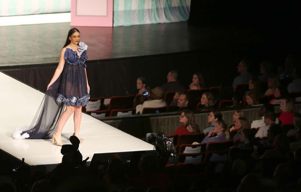 The audience watches April 15 as model Madison Tru wears "Luna" by Iowa State University student designer Brooke Mulholland during The Fashion Show at Stephens Auditorium in Ames. (Bailey Cichon/The Gazette)