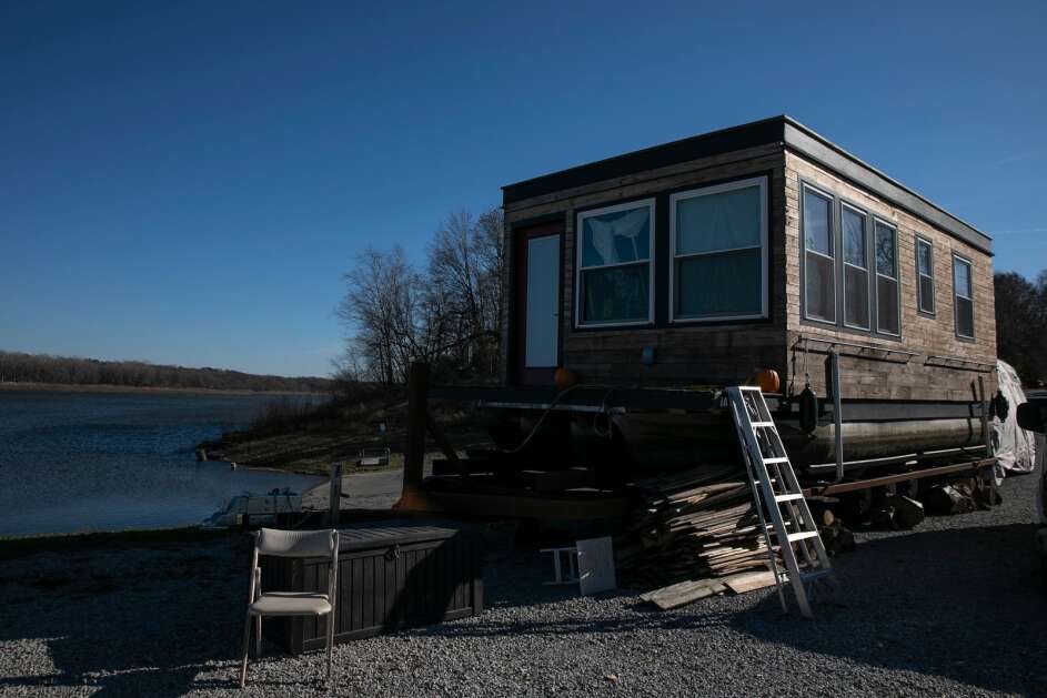 A houseboat sits on the shore in November 2021 at Coralville Lake in North Liberty. As the water levels decreased in 2021, boating on the lake was no longer viable. (Geoff Stellfox/The Gazette)