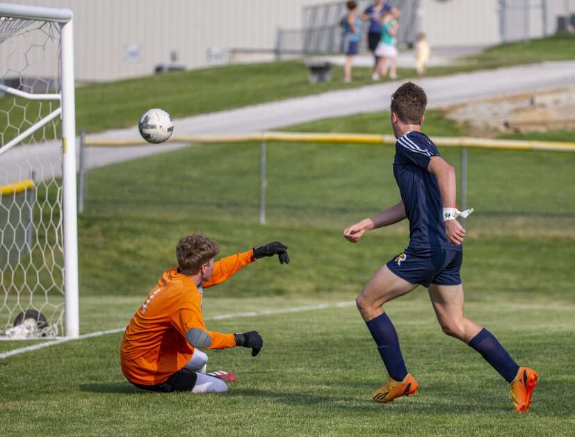 Iowa City Regina’s Eddie Petersen scores a goal against Dyersville Beckman in a Class 1A boys’ soccer substate final on Wednesday. (Savannah Blake/The Gazette)