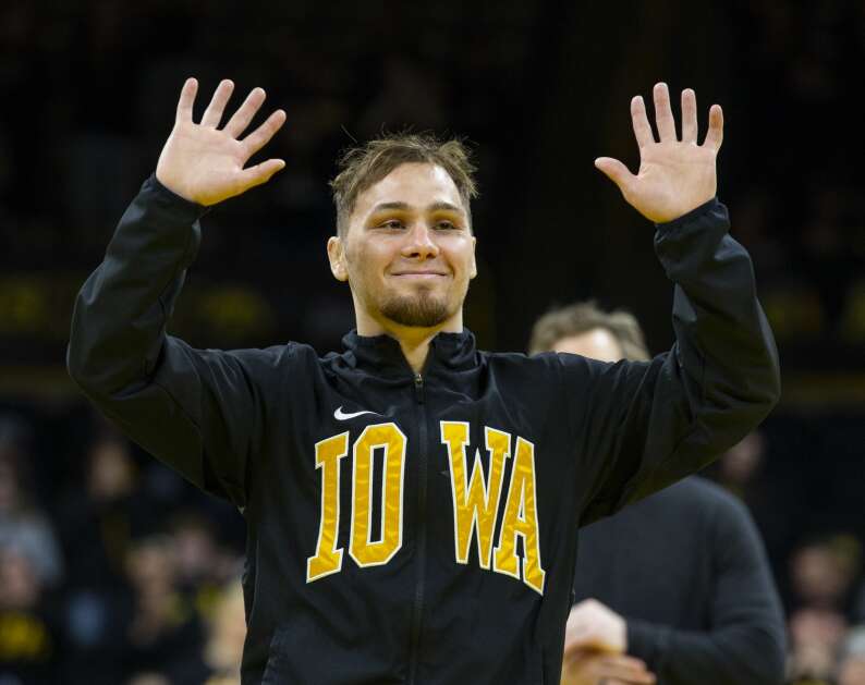 Iowa’s Spencer Lee waves to the crowd as he is honored during senior night for his accomplishments while at Iowa at Carver-Hawkeye Arena in Iowa City, Iowa on Sunday, February 19, 2023. (Savannah Blake/The Gazette)