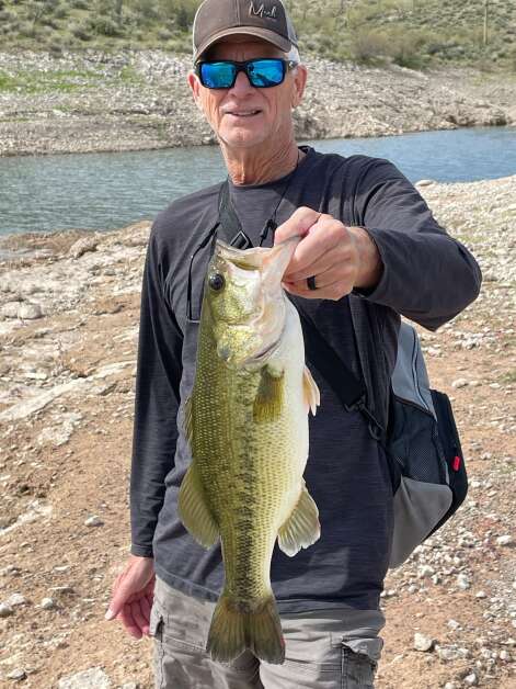 A chest bump was in order after Mike Wirth landed this 4-pound-plus Lake Pleasant largemouth bass. (Doug Newhoff/correspondent)