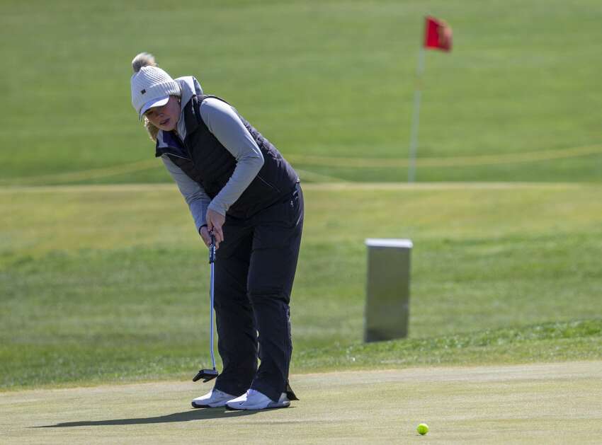 Liberty’s Bella Pettersen watches her ball after putting on the green during the girls’ MVC super meet at Airport National Golf Course in Cedar Rapids, Iowa on Monday, May 1, 2023. (Savannah Blake/The Gazette)