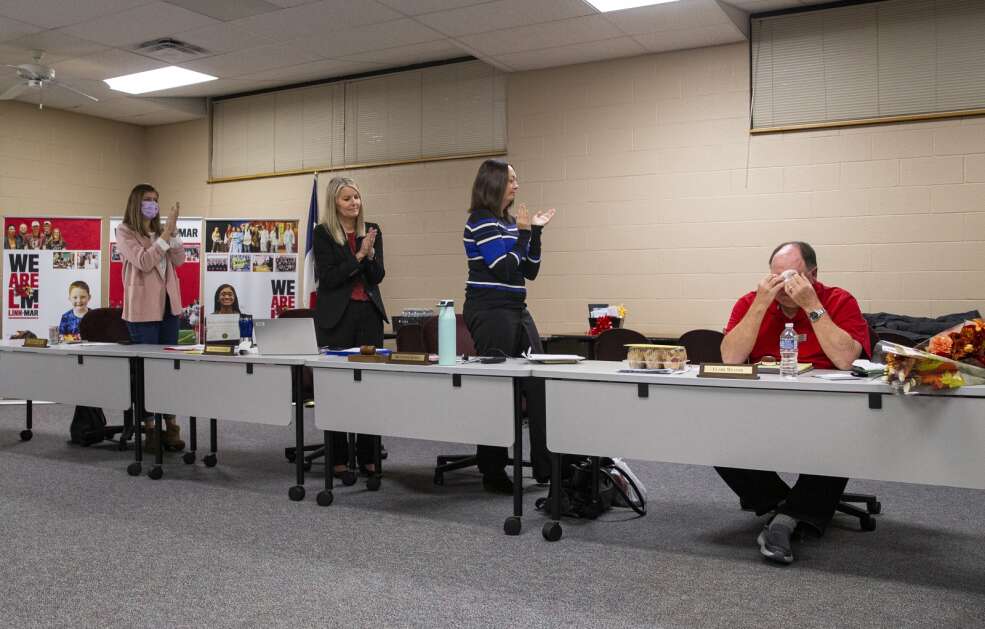 Linn-Mar school board member Clark Weaver, right, shows emotion as he fellow board members give him a standing applause for his final night on the board after serving two terms at the Linn-Mar Community School District building in Marion, Iowa on Monday, Nov. 20, 2023. (Savannah Blake/The Gazette)