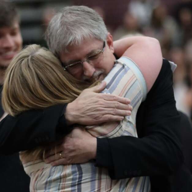 Jim DePriest hugs music booster Meg Richtman following a sentimental presentation of a farewell gift. (Photo Courtesy of MPTV-CloseUp)