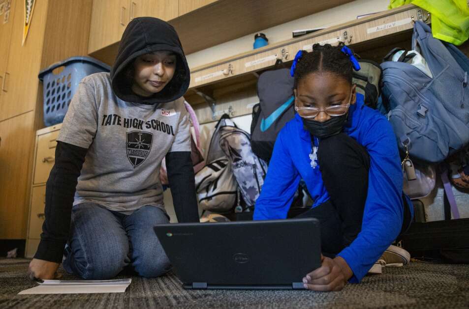 Tate High School student Emily Ortiz, 17, helps sixth-grader Laylonnie Richardson with her computer work Tuesday during class at Lucas Elementary School in Iowa City. Students like Ortiz in the “Educators Rising” program visit classrooms to work with elementary students to learn more about a career path to becoming a teacher. (Savannah Blake/The Gazette)