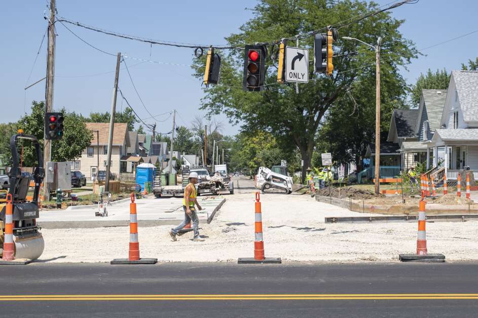 Construction crew members work Wednesday on a traffic project along Mount Vernon Road SE in Cedar Rapids. Work is underway on a $7.8 million project, funded by the voter-approved Paving for Progress program, to improve the road between 14th and 20th streets SE. (Savannah Blake/The Gazette)