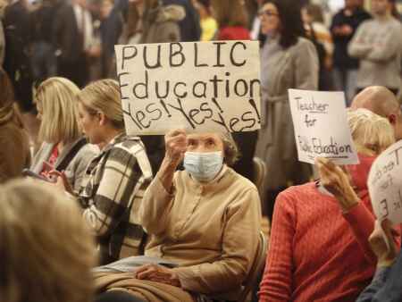 Scores of Iowans pack hearing on tuition aid bill