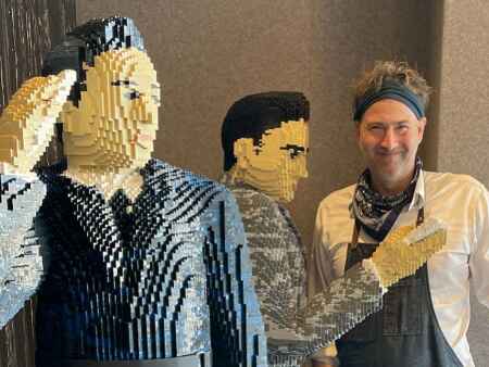ISU alum building life-size G.W. Carver Lego sculpture for fairgoers