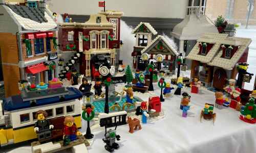 Mother and son build Lego Christmas Village