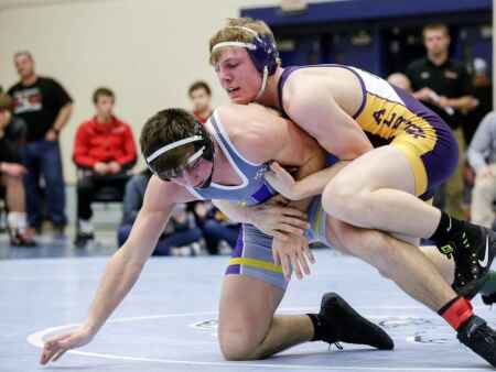 Pins and pens: Alburnett's Tanner Sloan works hard on the mat and the farm