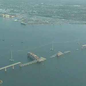 Cargo ship hits Baltimore bridge, bringing it down. Rescuers are looking for people in water.