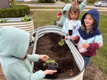 Mann Elementary kids plant community garden with Climate Action Grant