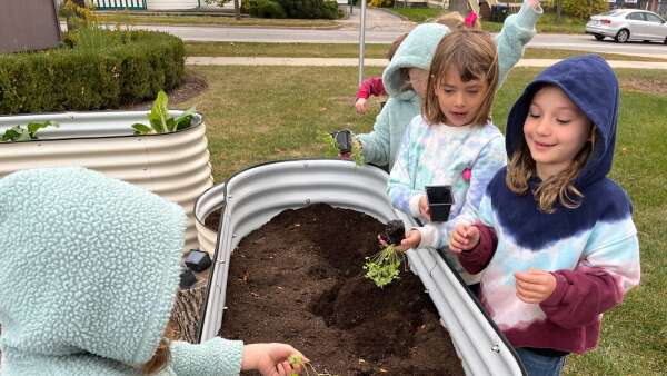 Mann Elementary kids plant community garden with Climate Action Grant