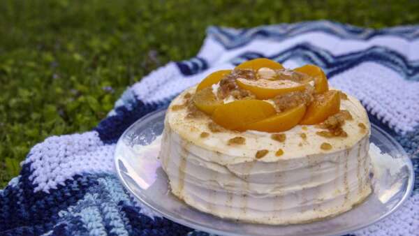 Peach Cobbler Cake combines two desserts into one tasty treat